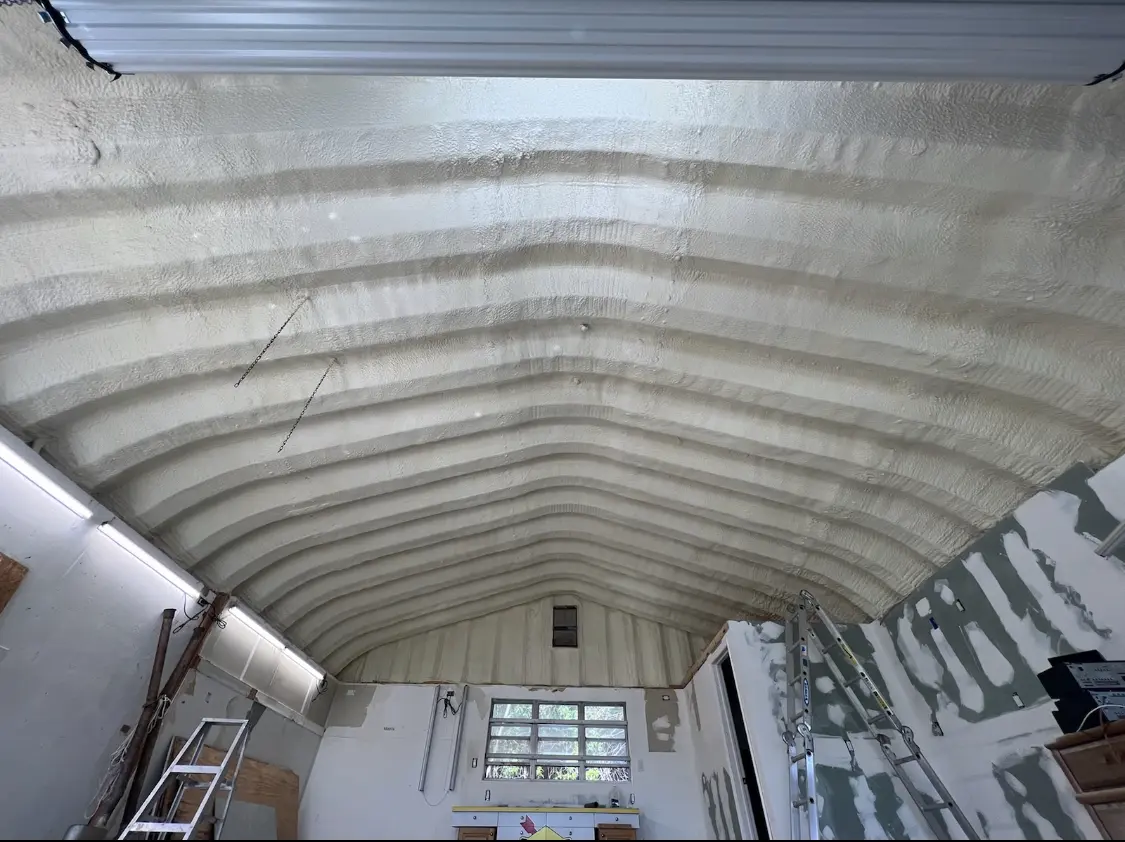 Spray polyurethane foam applied to the underside of a metal roof deck in East Moline